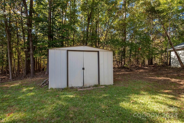 view of outbuilding with a lawn