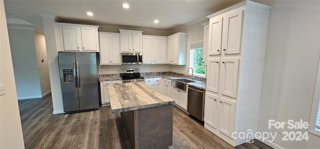 kitchen with white cabinetry, a center island, stainless steel appliances, and dark hardwood / wood-style floors