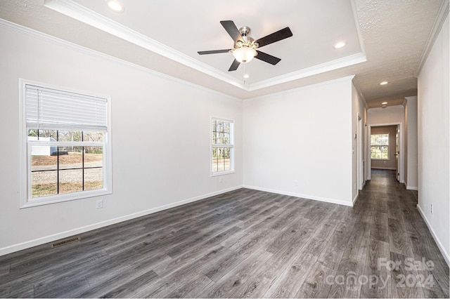 unfurnished room featuring dark hardwood / wood-style floors, crown molding, and a tray ceiling