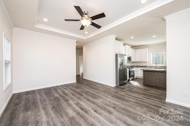 unfurnished living room with dark hardwood / wood-style floors, sink, and crown molding