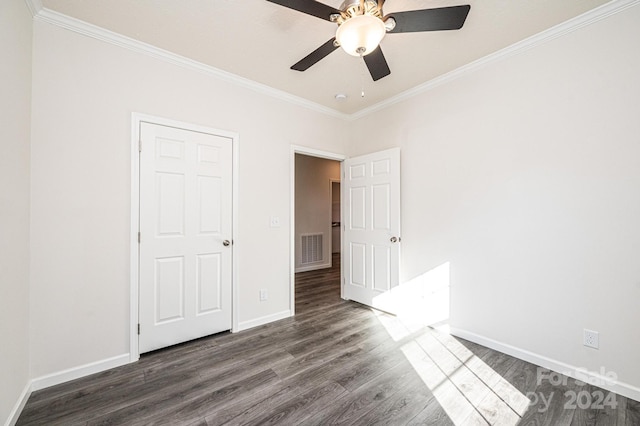 unfurnished bedroom featuring ornamental molding, ceiling fan, and dark wood-type flooring