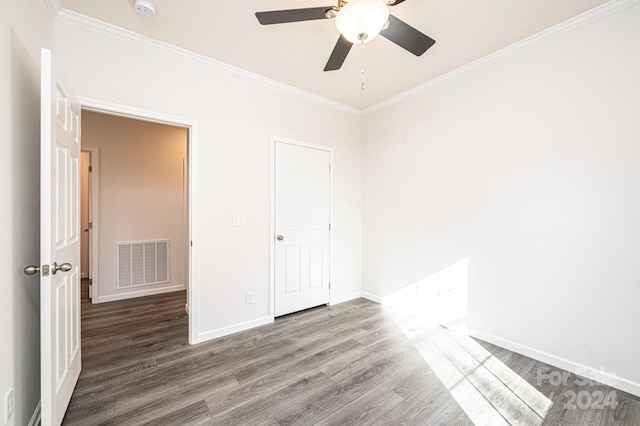 unfurnished bedroom featuring hardwood / wood-style floors, ceiling fan, and crown molding