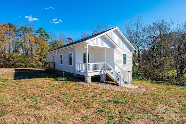 view of front of house with a front yard and a porch