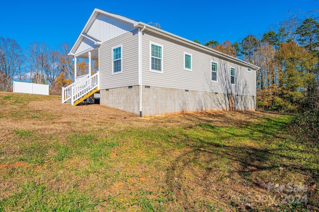 view of property exterior with a yard