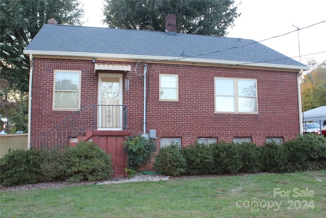 view of side of home with a lawn