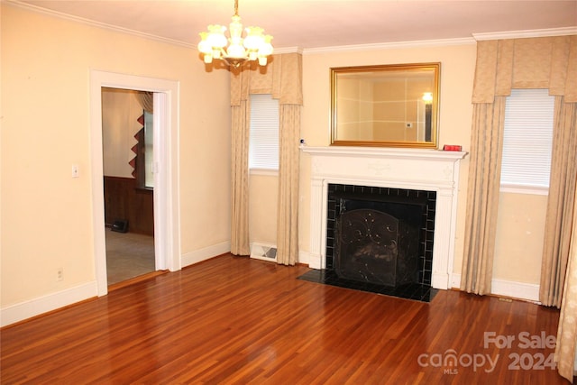 unfurnished living room featuring crown molding, a notable chandelier, and dark hardwood / wood-style flooring