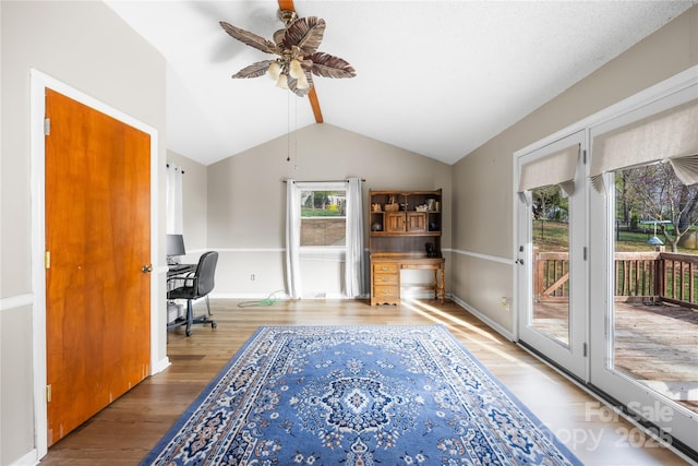 office area with wood-type flooring, lofted ceiling, and ceiling fan