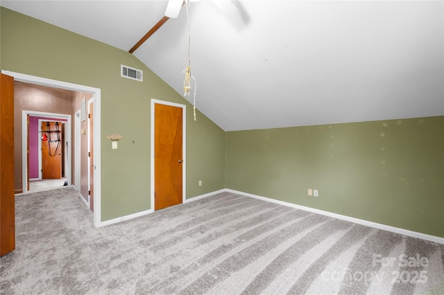 additional living space with ceiling fan, light colored carpet, and vaulted ceiling