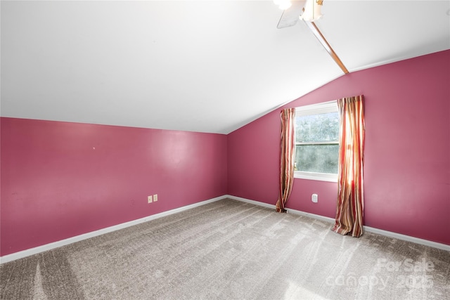 additional living space with carpet flooring and vaulted ceiling