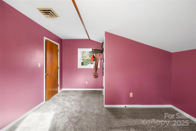 carpeted empty room with lofted ceiling