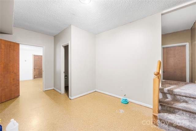 unfurnished room featuring a textured ceiling