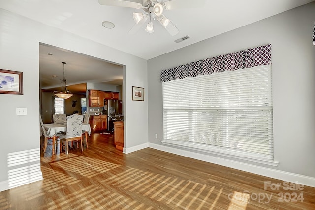 interior space featuring dark wood-type flooring and ceiling fan