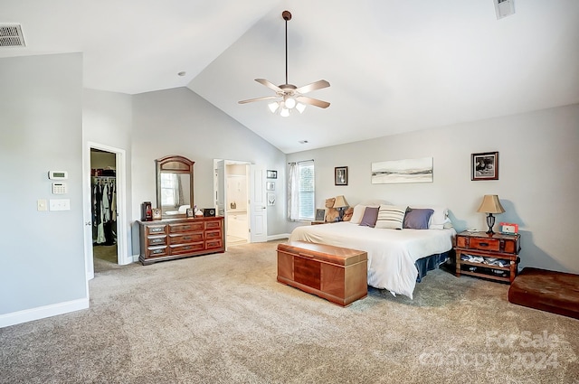 bedroom with carpet flooring, ceiling fan, a walk in closet, and connected bathroom