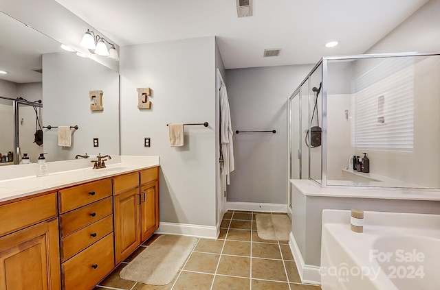 bathroom featuring vanity, tile patterned floors, and an enclosed shower