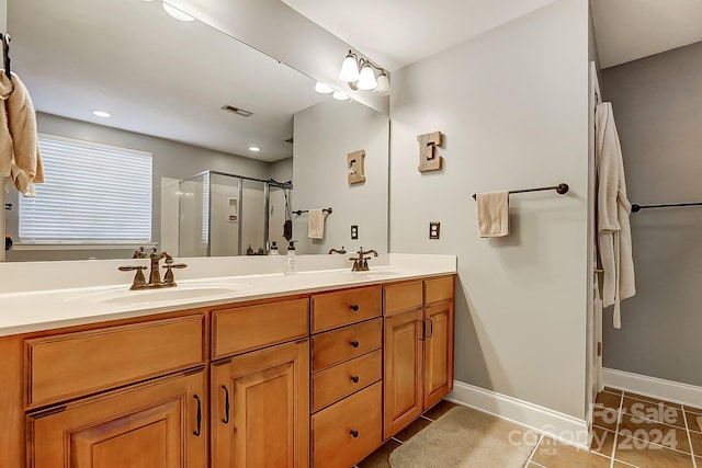 bathroom featuring vanity, walk in shower, and tile patterned floors