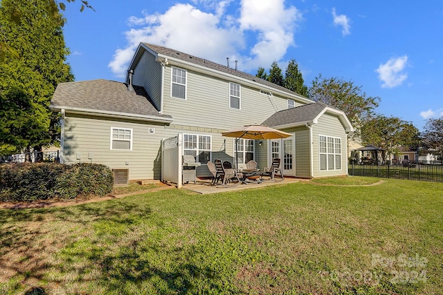 rear view of house with a patio, central AC unit, and a yard