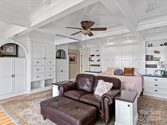 bedroom with wood-type flooring, ceiling fan, coffered ceiling, beamed ceiling, and ornamental molding