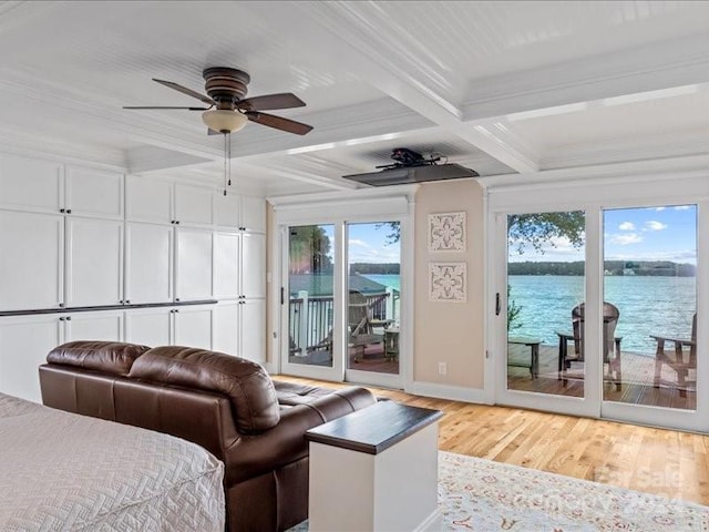 interior space with coffered ceiling, access to exterior, beam ceiling, light hardwood / wood-style flooring, and a water view