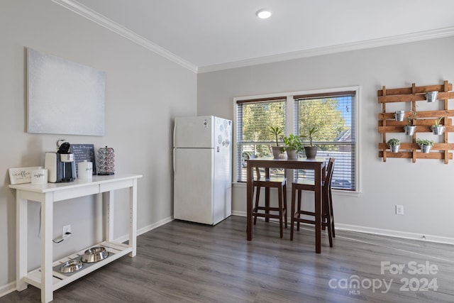 dining room featuring dark hardwood / wood-style floors and crown molding