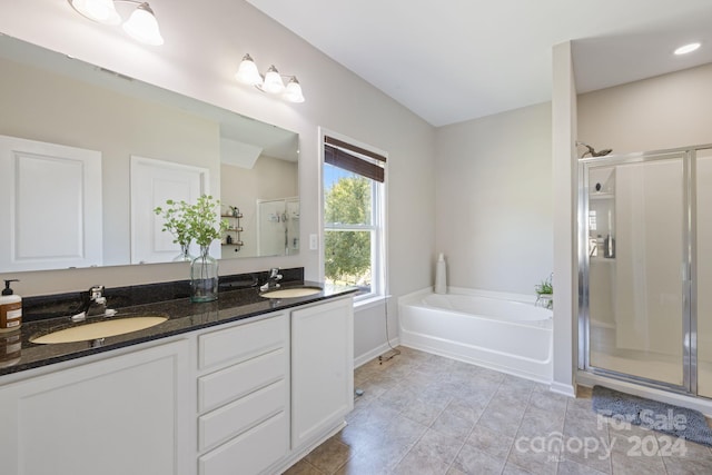 bathroom featuring vanity and shower with separate bathtub