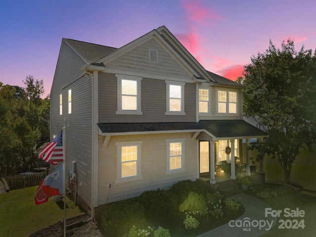 view of front of home featuring a porch and a yard