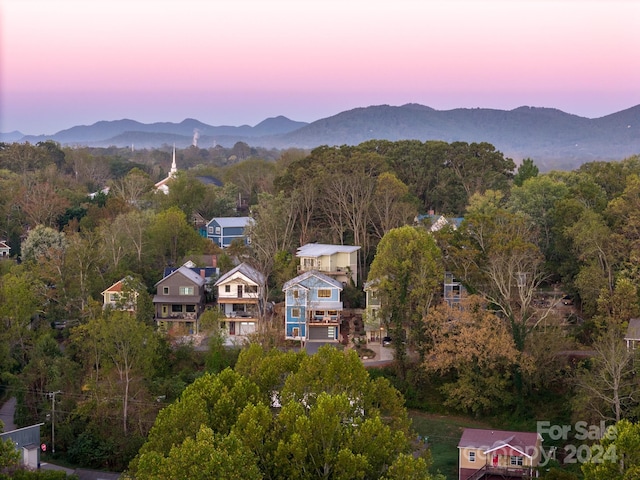 aerial view at dusk featuring a mountain view