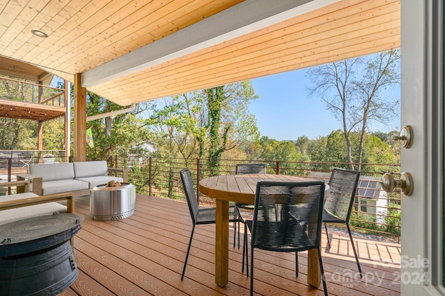 wooden deck with an outdoor living space