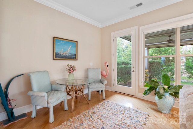 interior space with ornamental molding and light hardwood / wood-style flooring