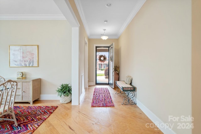 foyer entrance with hardwood / wood-style floors and crown molding