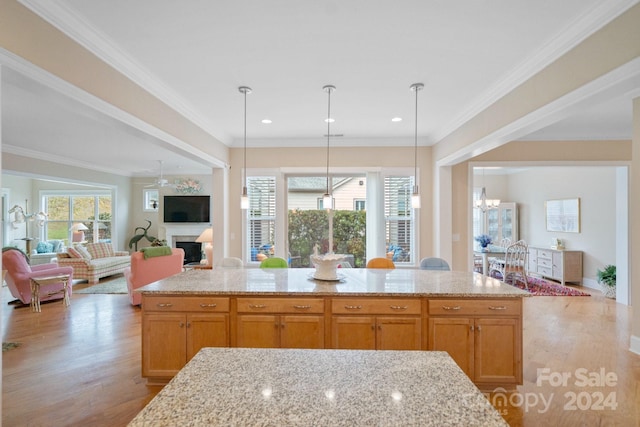 kitchen featuring plenty of natural light, light wood-type flooring, and ornamental molding