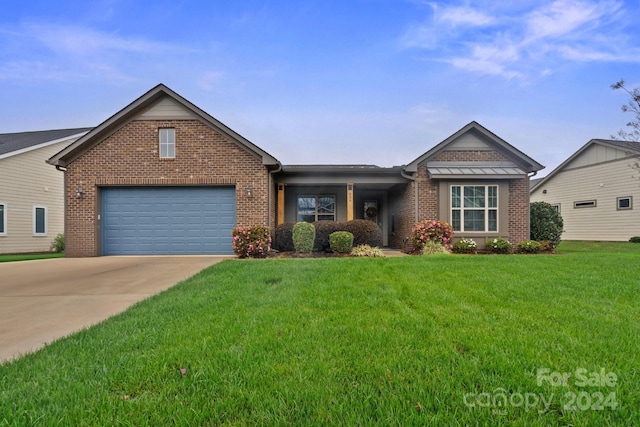 ranch-style house featuring a garage and a front yard