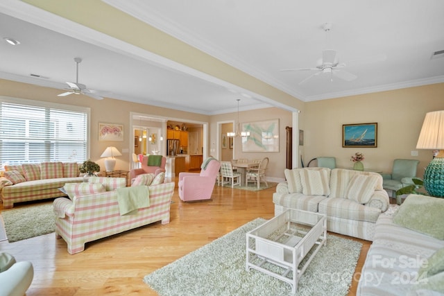 living room with ceiling fan with notable chandelier, hardwood / wood-style flooring, and crown molding