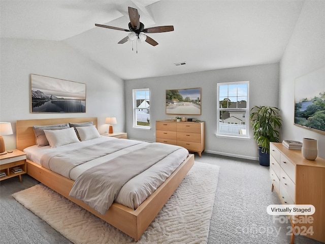 carpeted bedroom featuring ceiling fan and lofted ceiling