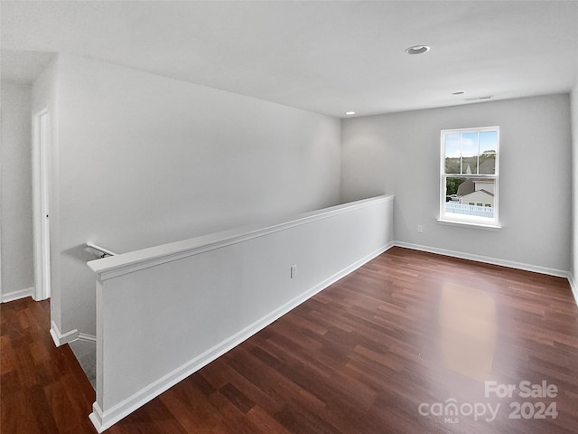 spare room with dark hardwood / wood-style flooring