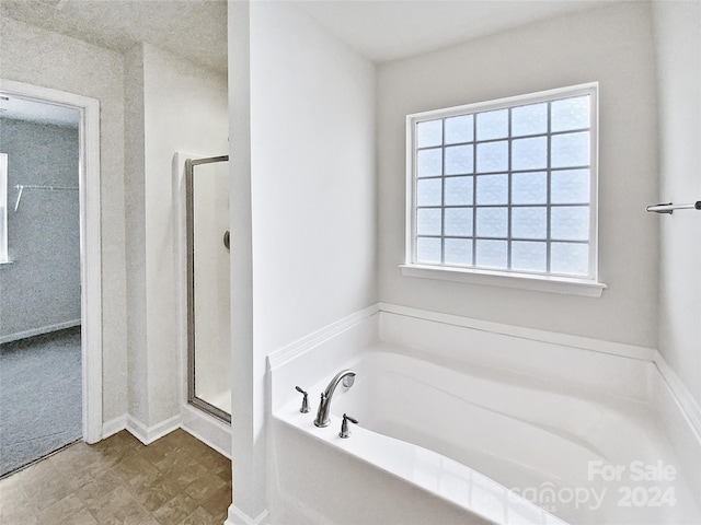 bathroom featuring plus walk in shower