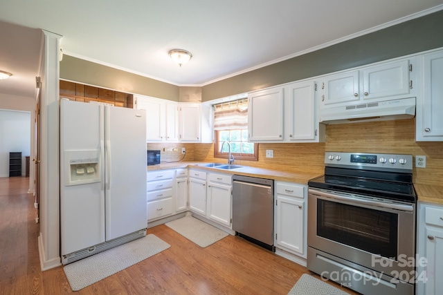 kitchen featuring light hardwood / wood-style floors, white cabinets, stainless steel appliances, and backsplash