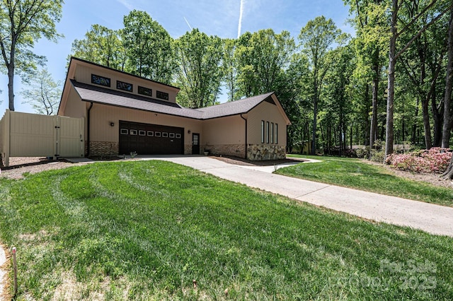 view of front of property with a garage and a front yard