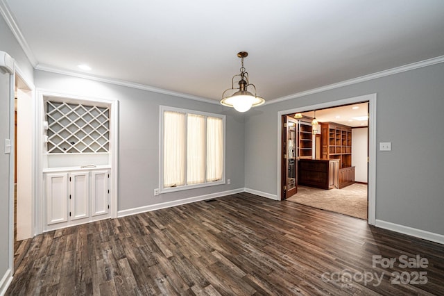 unfurnished dining area featuring crown molding and dark hardwood / wood-style floors