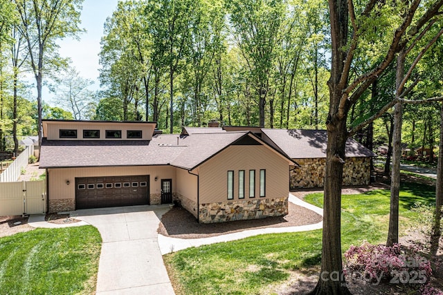 view of front of home with a garage and a front lawn