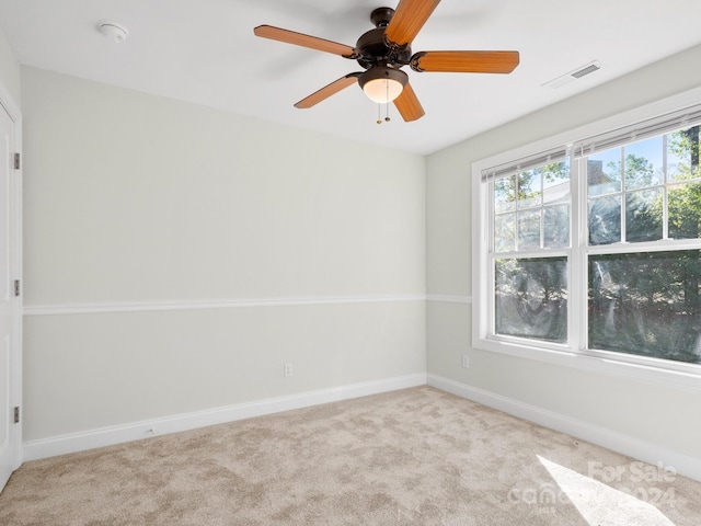 carpeted empty room featuring ceiling fan