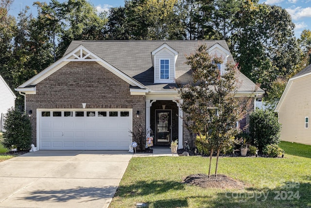 view of front of house with a front yard and a garage