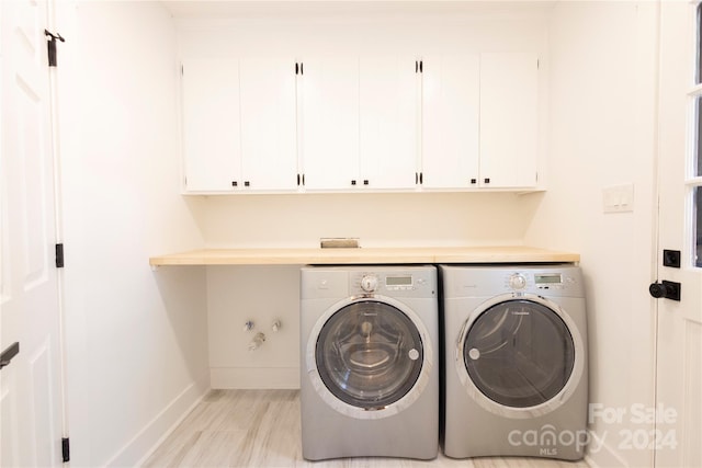 8946 Glencroft Rd, Mint Hill, NC 28227 - washroom with cabinet space, baseboards, washing machine and dryer, and light wood-style floors