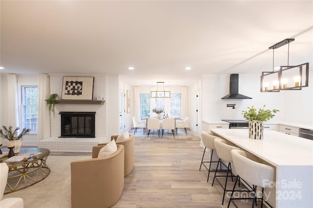 8946 Glencroft Rd, Mint Hill, NC 28227 - living area with light wood-type flooring, recessed lighting, a fireplace, and a chandelier
