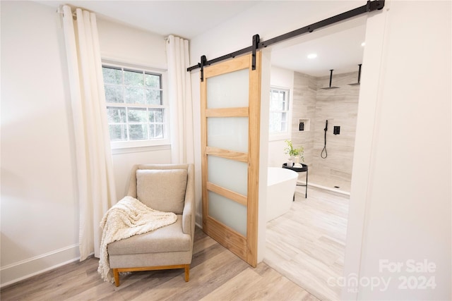 8946 Glencroft Rd, Mint Hill, NC 28227 - living area featuring a barn door, wood finished floors, baseboards, and recessed lighting