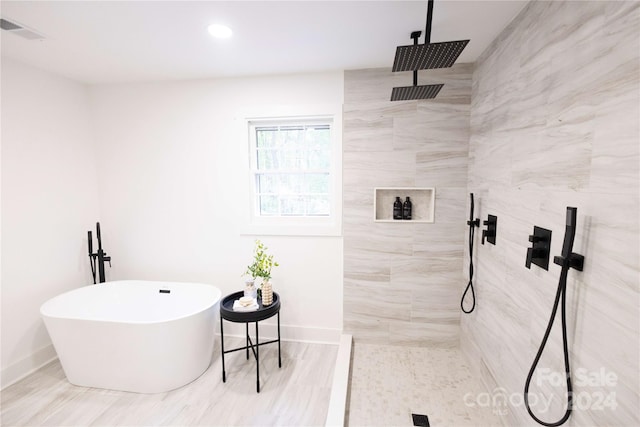 bathroom with hardwood / wood-style floors and plus walk in shower