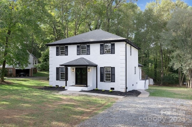 colonial-style house with a front lawn