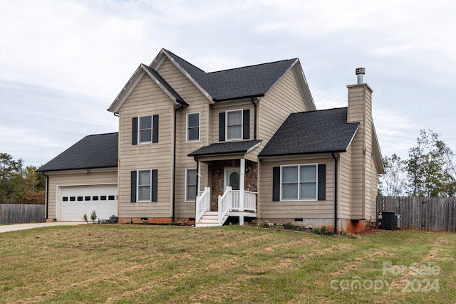 front facade with a front lawn, central AC, and a garage