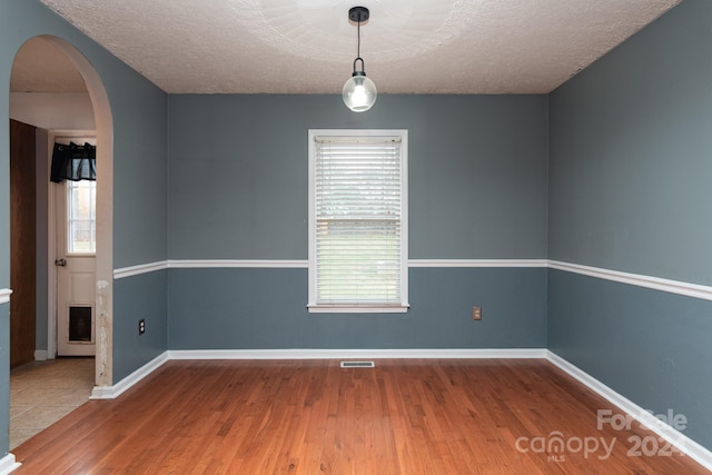 empty room featuring hardwood / wood-style floors and a textured ceiling