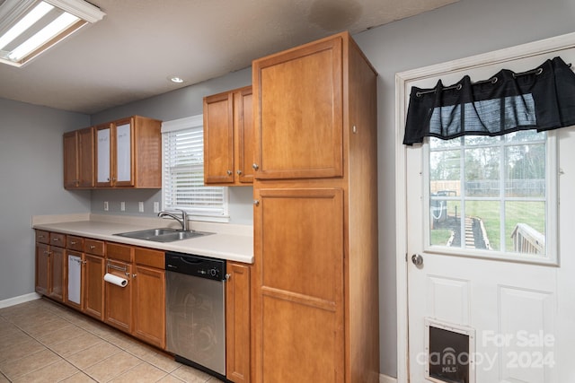 kitchen with sink, light tile patterned flooring, and dishwasher