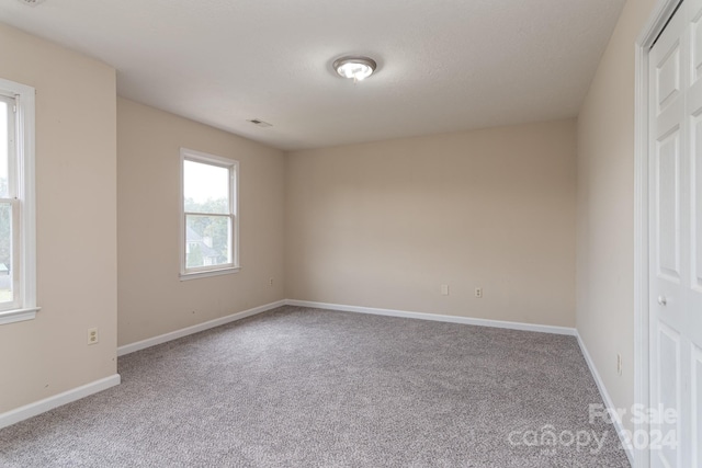 empty room with carpet flooring